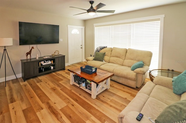 living room with light hardwood / wood-style floors and ceiling fan