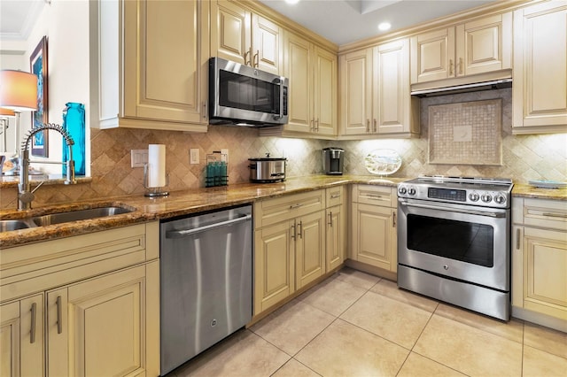 kitchen featuring sink, appliances with stainless steel finishes, tasteful backsplash, and stone countertops