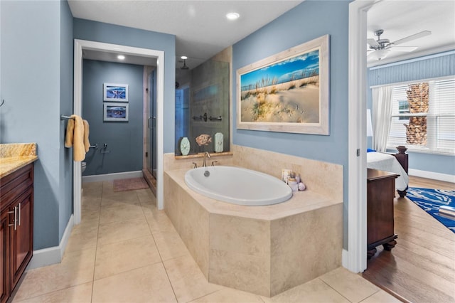 bathroom featuring vanity, tile flooring, independent shower and bath, and ceiling fan