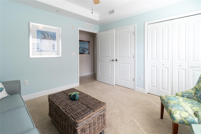 living room featuring light carpet and ceiling fan