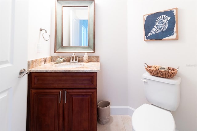 bathroom featuring toilet, tile floors, and vanity