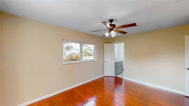 unfurnished room with ceiling fan and dark hardwood / wood-style floors