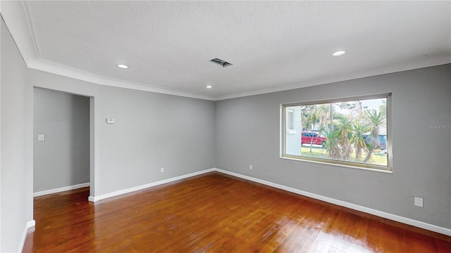 unfurnished room with dark hardwood / wood-style flooring, a textured ceiling, and ornamental molding