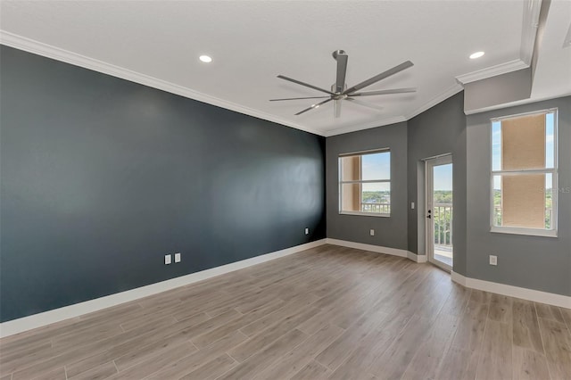 empty room featuring crown molding, ceiling fan, and light hardwood / wood-style flooring