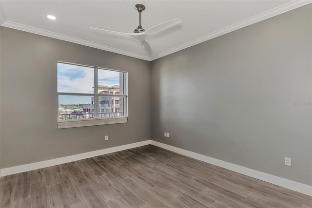 spare room featuring crown molding, hardwood / wood-style floors, and ceiling fan