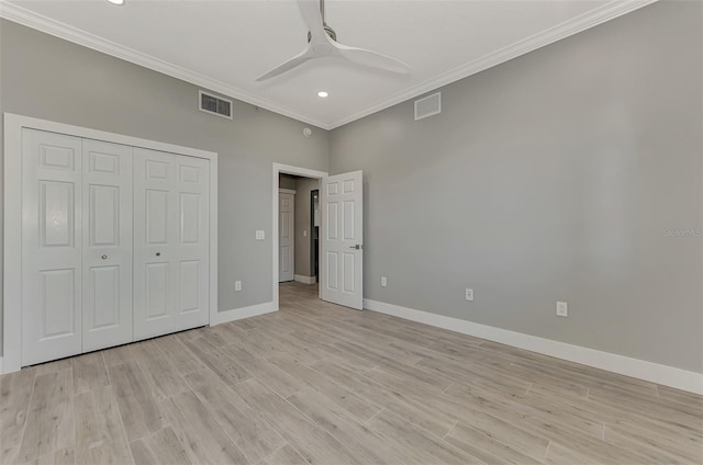 unfurnished bedroom with a closet, ceiling fan, light wood-type flooring, and crown molding