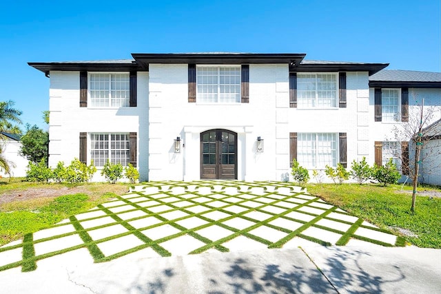 rear view of property featuring a lawn