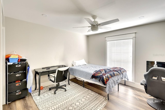 bedroom with ceiling fan and light wood-type flooring