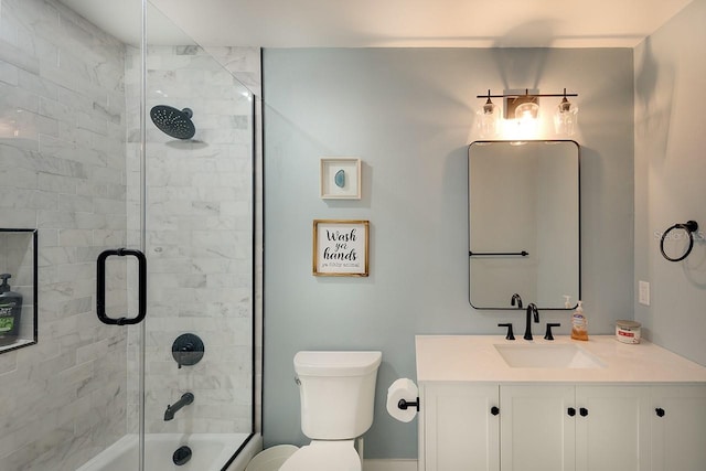 full bathroom featuring toilet, vanity, and bath / shower combo with glass door