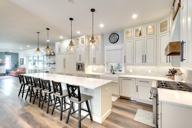 kitchen featuring light hardwood / wood-style floors, a healthy amount of sunlight, and white cabinetry