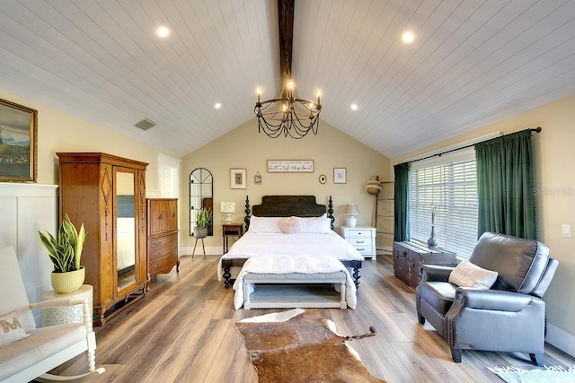 bedroom with an inviting chandelier, vaulted ceiling with beams, light hardwood / wood-style floors, and wooden ceiling