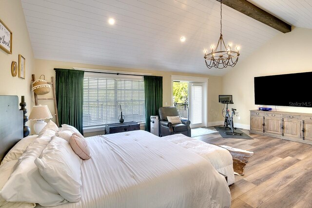 bedroom with lofted ceiling with beams, light hardwood / wood-style floors, and a chandelier