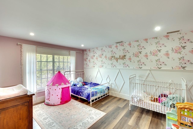 bedroom with dark hardwood / wood-style floors