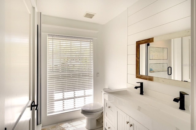 bathroom with vanity, plenty of natural light, and toilet