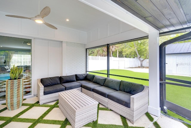 sunroom featuring ceiling fan