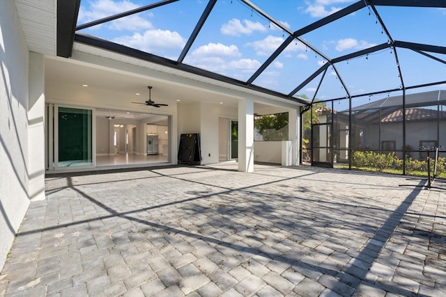 view of patio with glass enclosure and ceiling fan