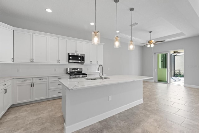 kitchen with white cabinetry, a kitchen island with sink, sink, and stainless steel appliances