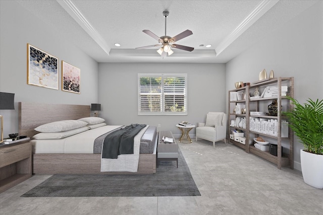 bedroom featuring a raised ceiling, ceiling fan, crown molding, and a textured ceiling