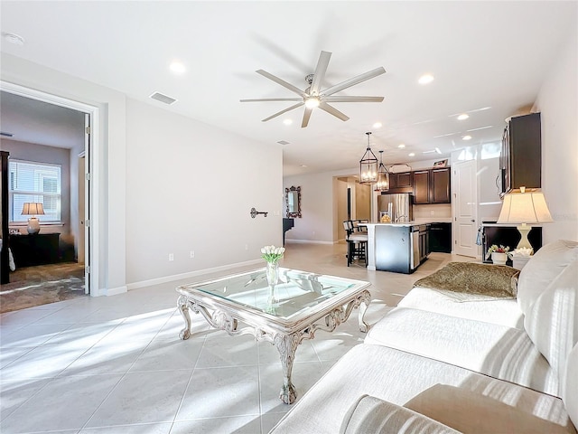 living room featuring ceiling fan and light tile patterned floors