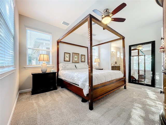 carpeted bedroom with connected bathroom and ceiling fan