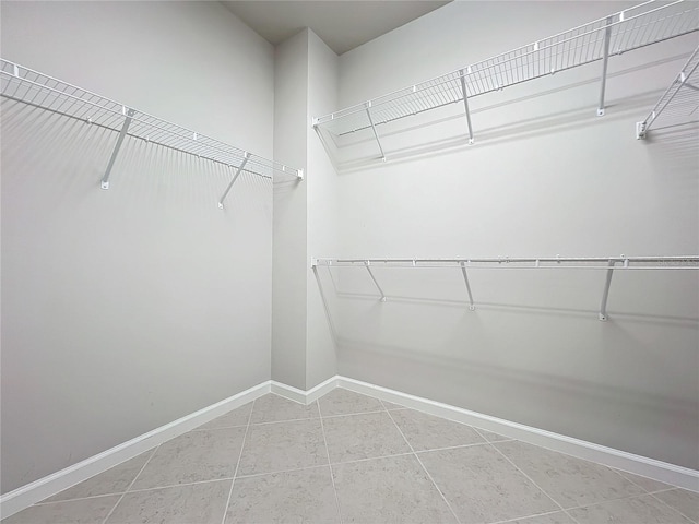 walk in closet with tile patterned flooring