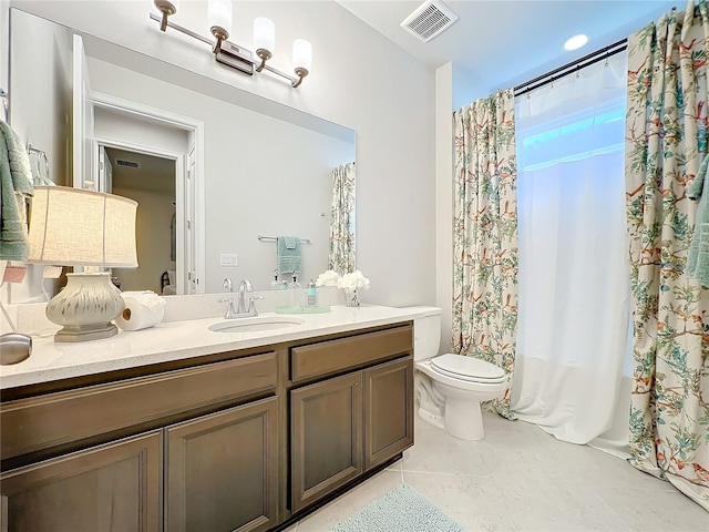 bathroom featuring tile patterned flooring, vanity, and toilet