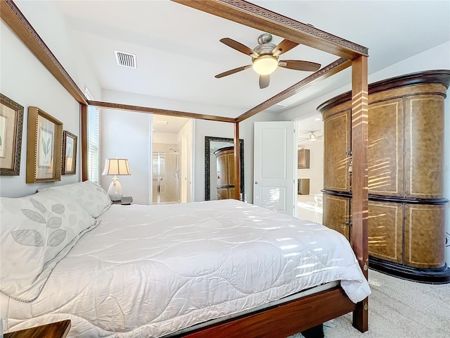 carpeted bedroom with ensuite bathroom and ceiling fan