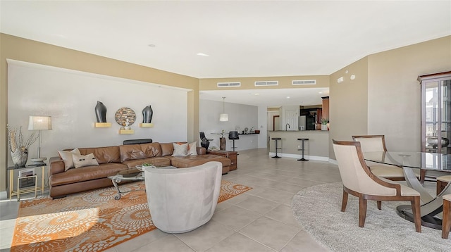 tiled living room featuring sink