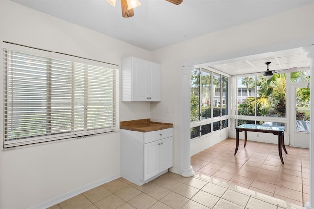 kitchen with white cabinets, ceiling fan, and light tile patterned flooring