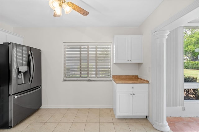 kitchen with stainless steel fridge, white cabinetry, ceiling fan, and a healthy amount of sunlight