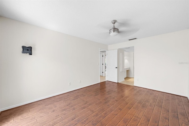 empty room featuring light wood-type flooring and ceiling fan