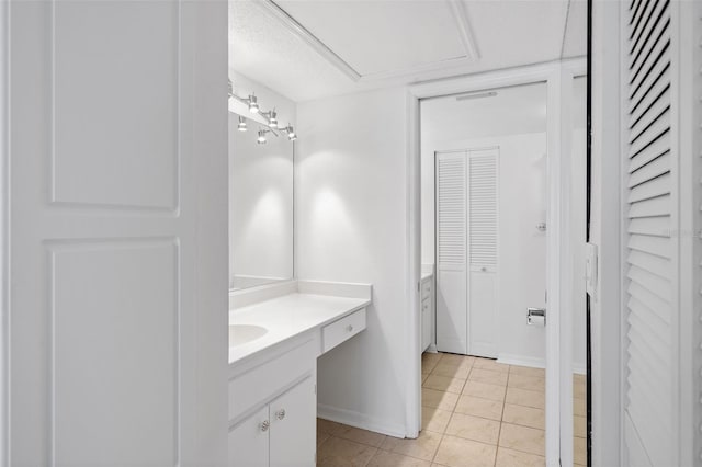 bathroom featuring a textured ceiling, vanity, and tile patterned floors