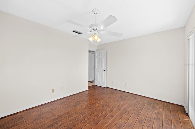 unfurnished room with dark hardwood / wood-style flooring