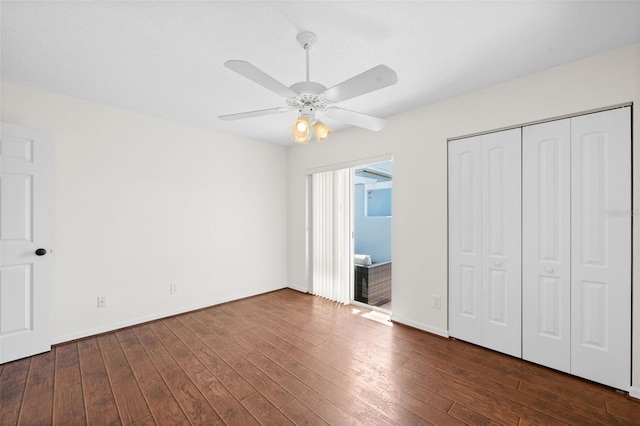 unfurnished bedroom featuring a closet, ceiling fan, and dark hardwood / wood-style floors