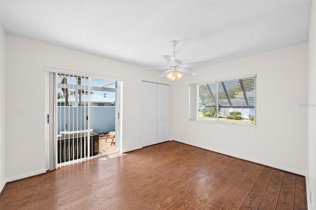 unfurnished room featuring wood-type flooring, a textured ceiling, and ceiling fan