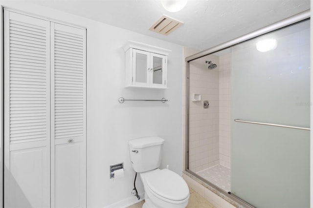 bathroom with toilet and an enclosed shower