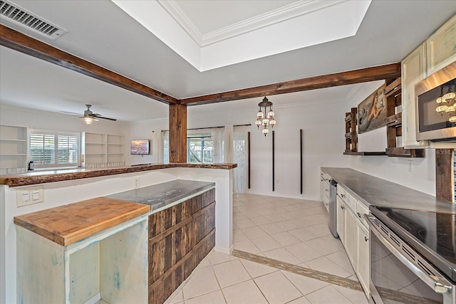 kitchen with ceiling fan with notable chandelier, light tile flooring, stainless steel appliances, wood counters, and pendant lighting