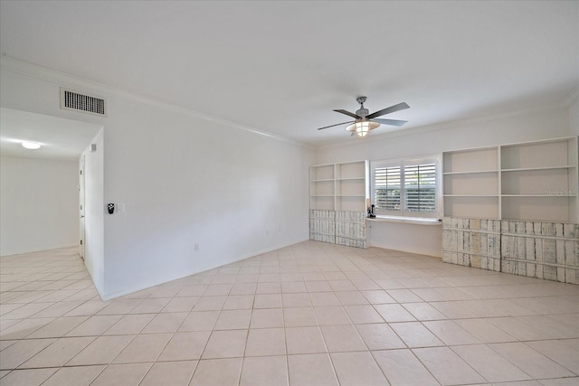 tiled empty room featuring built in features, ceiling fan, and crown molding