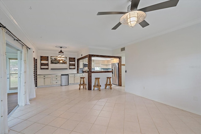 interior space featuring light tile floors, ceiling fan with notable chandelier, and ornamental molding