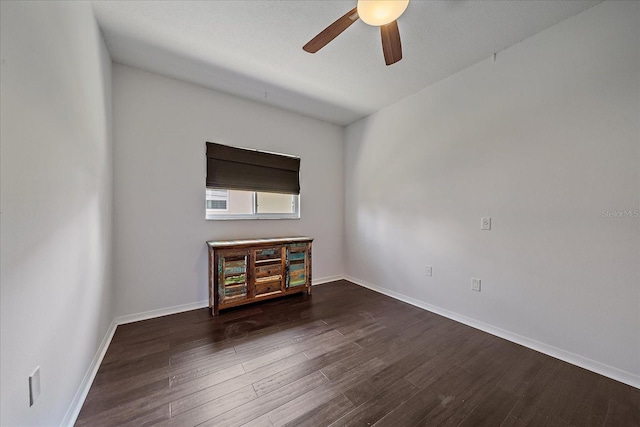 unfurnished living room with dark hardwood / wood-style floors and ceiling fan