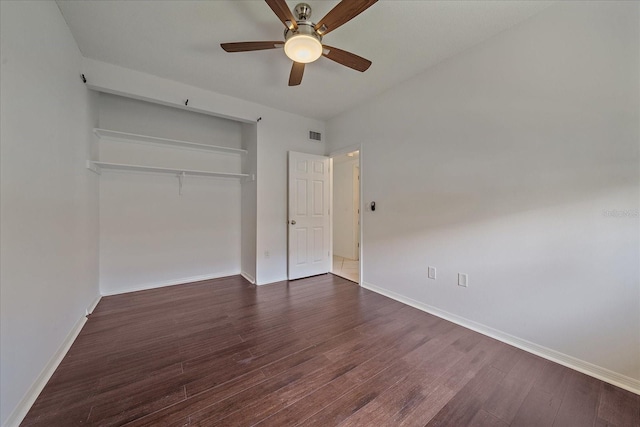 unfurnished bedroom with a closet, ceiling fan, and dark hardwood / wood-style flooring