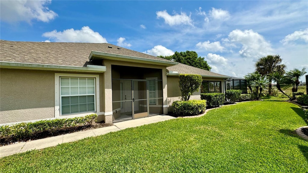 rear view of house with a yard