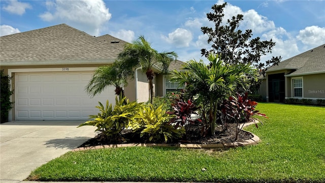 view of front of house featuring a front yard and a garage