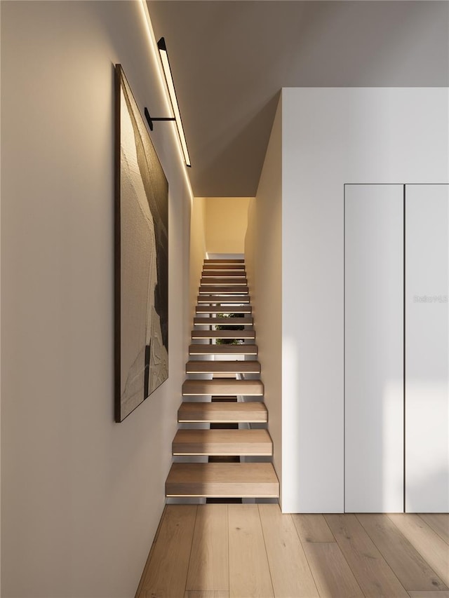 stairway featuring light hardwood / wood-style floors