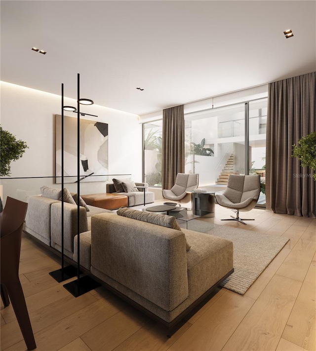 living room featuring light hardwood / wood-style floors and a wall of windows