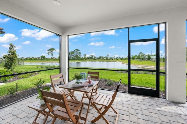 sunroom with a water view and plenty of natural light