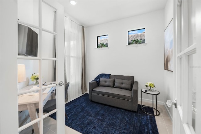 living area with french doors and tile flooring