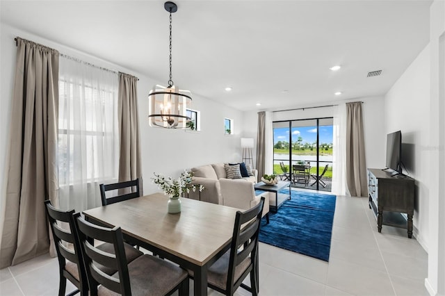 tiled dining area with an inviting chandelier