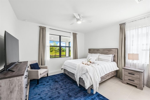 tiled bedroom featuring ceiling fan