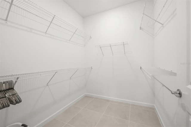 spacious closet featuring light tile floors